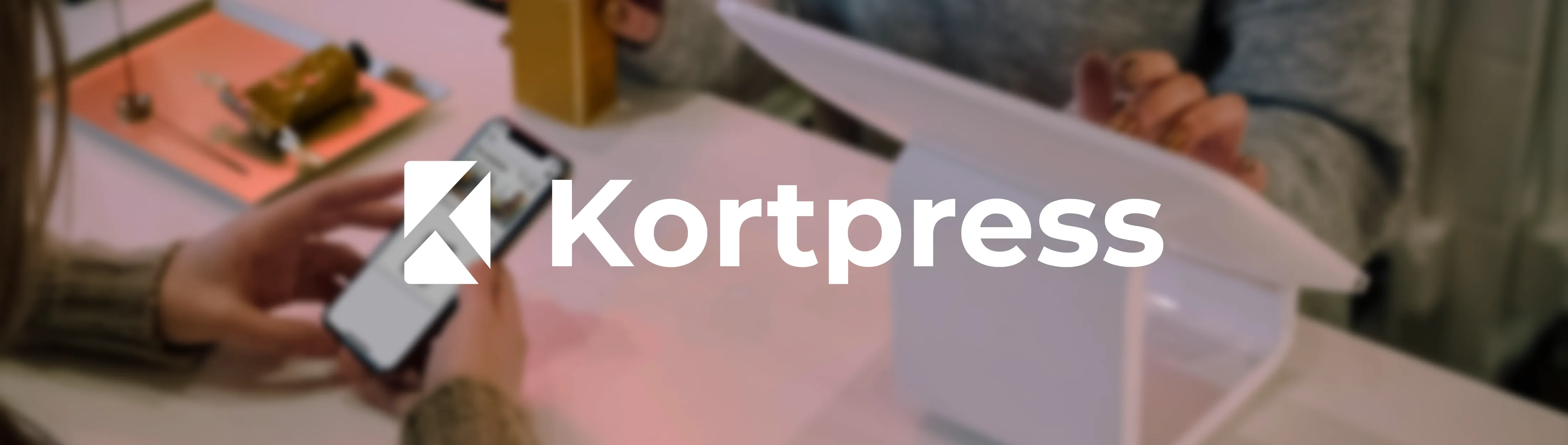 Kortpress dashboard on laptop beside smartphone with Apple and Google Wallet cards